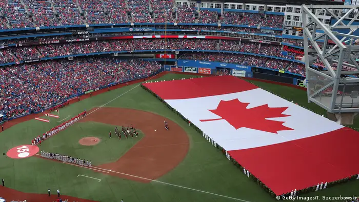 A Canadian flag on a baseball field (Getty Images/T. Szczerbowski)