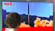 A woman watches a television showing North Korea's launch of an ICBM A woman watches a television showing North Korea's launch of an ICBM