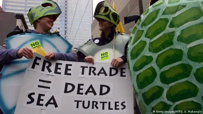 WTO protesters in sea turtle customes (Getty Images/AFP/J. G. Mabanglo)