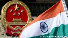 File - In this Wednesday, Oct. 23,2013, file photo, an Indian national flag is flown next to the Chinese national emblem during a welcome ceremony for visiting Indian officals outside the Great Hall of the People in Beijing. China is insisting that India withdraw its troops from a disputed Himalayan plateau before talks can take place to settle the most protracted standoff in recent years between the nuclear-armed neighbors. (AP Photo/Andy Wong, File) |