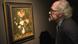 A man looks at the painting "Flowers in a Wan-Li Vase" by Balthasar van der Ast A man looks at the painting "Flowers in a Wan-Li Vase" by Balthasar van der Ast