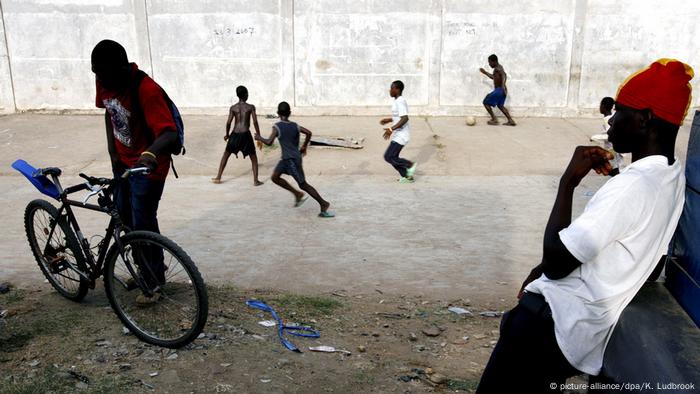 A youth watching boys playing football in Accra 