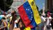 A woman holds a Venezuelan national flag A woman holds a Venezuelan national flag