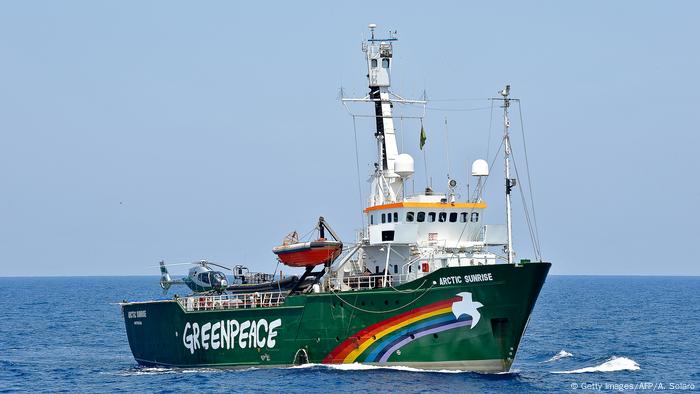 A ship with a rainbow in open seas