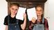 Two children holding paper Two children holding paper