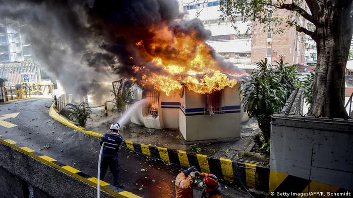 Firefighters trying to put out a fire in Caracas