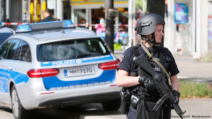German police stand guard after a knife attack in Hamburg