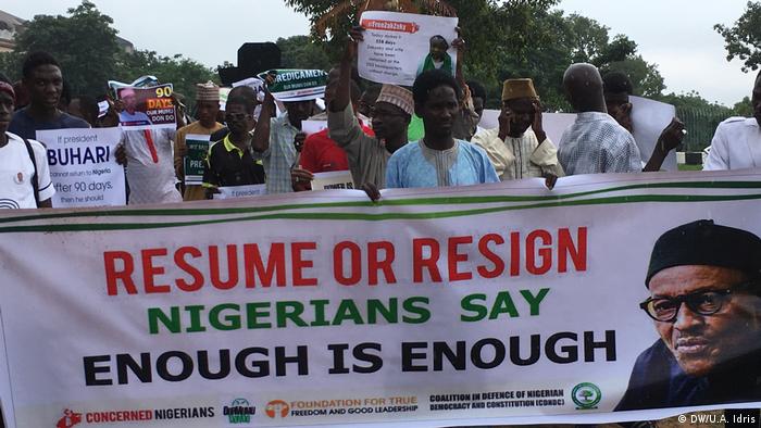 Protesters hold up banner saying 'Resume or resign, enough is enough'