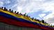 Opposition activists hold the Venezuelan flag Opposition activists hold the Venezuelan flag