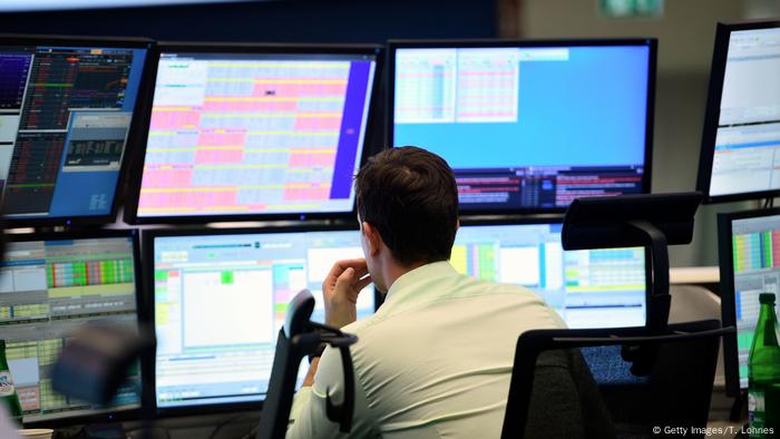  A trader sits at his desk at the Frankfurt Stock exchange.