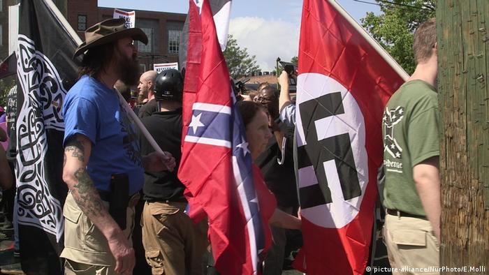 Demonstrators carry confederate and Nazi flags