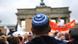 A person wearing a kippah, a Jewish head covering, attends an anti-Semitism rally in Berlin A person wearing a kippah, a Jewish head covering, attends an anti-Semitism rally in Berlin