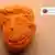 A picture of a police-secured, orange ecstasy pill in the shape of US President Donald Trump's face