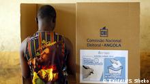 FILE PHOTO: A man casts his vote at a polling station during the national elections in the capital Luanda August 31, 2012. REUTERS/Siphiwe Sibeko/File Photo