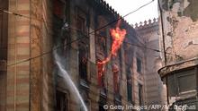 Firefighters douse flames inside the National Library in Sarajevo 26 August 1992. Thousands of books and historical documents are housed in the building which was hit by shells during artillery duels in the capital. An international conference in London met 26 August to resolve the conflict. (Photo credit should read MANOOCHER DEGHATI/AFP/Getty Images)