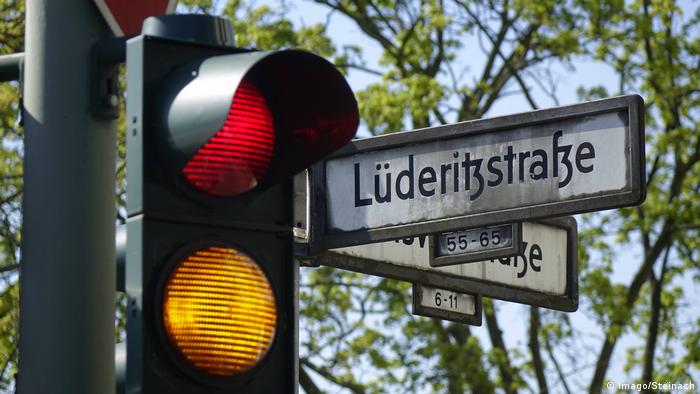A street sign with traffic lights, named after German colonist Lüderitz 