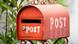 A red mailbox with the word Post written on it A red mailbox with the word Post written on it