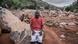 Fesellie Eveh sitting on the big boulders that crashed down the mountainside in the mudslide Fesellie Eveh sitting on the big boulders that crashed down the mountainside in the mudslide