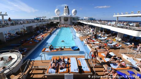 People gathered around a pool on a cruise ship 