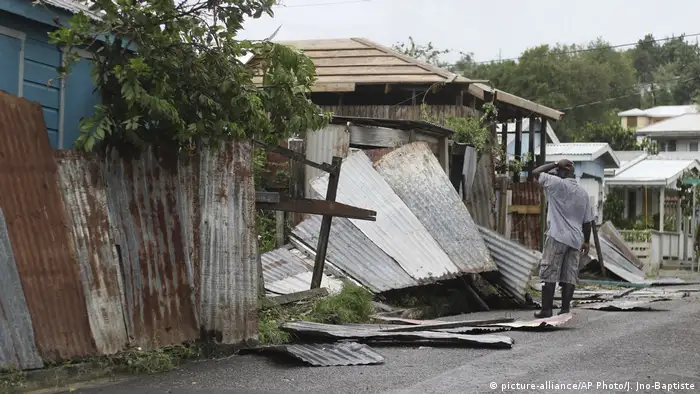 A man inspects the shattered remains of his home in Havana