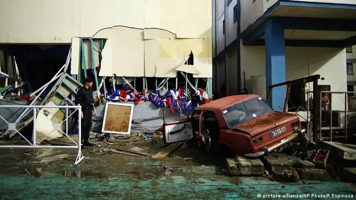 A vehicle lies embedded in the shattered Anti-Imperialist Tribune Building in Cuba