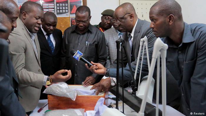 Tanzanian Minister for Finance and Planning Philipp Mpango and other government officials inspecting a box containing seized diamonds