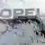 Opel sign seen through a windshield partially covered by snow