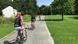 Three cyclists riding along the Berlin Wall trail Three cyclists riding along the Berlin Wall trail