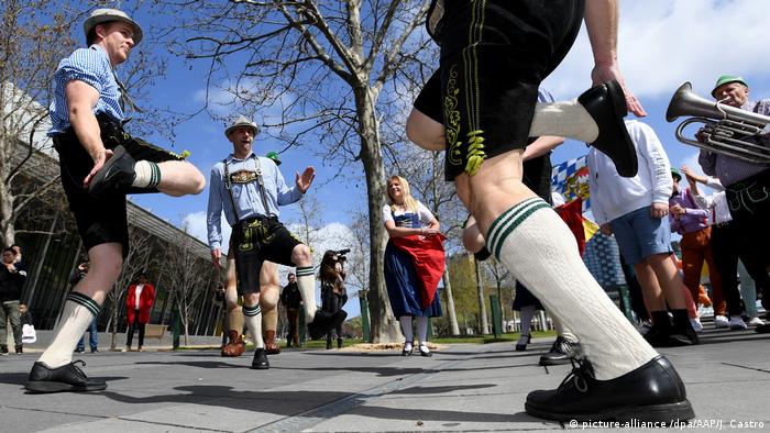 People perform traditional Bavarian Oktoberfest dance in a street in Melbourne, Australia.