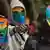 LGBTQ activists in rainbow masks at a protest in Kenya