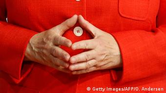German chancellor Angela Merkel makes her signature hands-together gesture