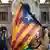 A protester holds a Catalan flag