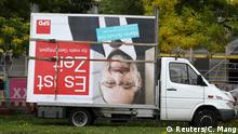 Workers remove an election campaign billboard showing Social Democratic Party SPD leader and top candidate Martin Schulz, the day after the general election (Bundestagswahl) in Berlin, Germany September 25, 2017. REUTERS/Christian Mang