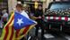 A woman holds a Catalan separatist flag in front of a Mossos police van REUTERS/Susana Vera A woman holds a Catalan separatist flag in front of a Mossos police van REUTERS/Susana Vera