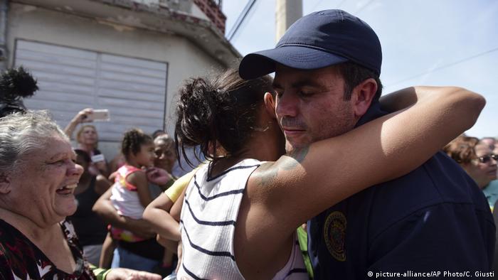 Puerto Rico Governor Ricardo Rossello is greeted by a resident in Barrio Obrero