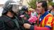 A man gives a carnation to a Spanish Guardia Civil guard in Sant Julia de Ramis on the day of a banned Catalonia independence referendum A man gives a carnation to a Spanish Guardia Civil guard in Sant Julia de Ramis on the day of a banned Catalonia independence referendum