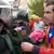 A man gives a carnation to a Spanish Guardia Civil guard in Sant Julia de Ramis on the day of a banned Catalonia independence referendum