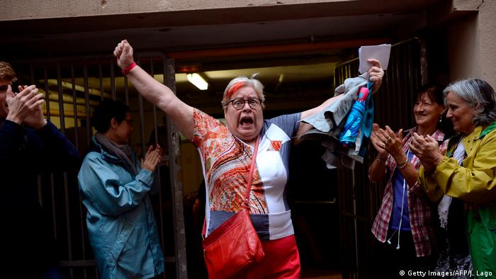 Woman raising her arms in triumph outside a polling station (Getty Images/AFP/J. Lago) (Getty Images/AFP/J. Lago)