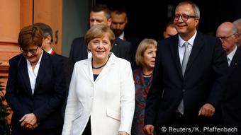 Federal Constitutional Court President Andreas Vosskuhle and wife Eva and German Chancellor Angela Merkel during German Unification Day celebrations in Mainz, Germany Federal Constitutional Court President Andreas Vosskuhle and wife Eva and German Chancellor Angela Merkel during German Unification Day celebrations in Mainz, Germany
