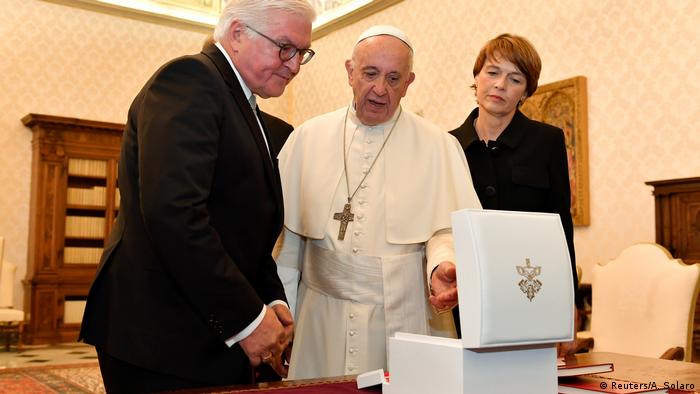 Pope Francis exchanges gift with German President Frank-Walter Steinmeier (L) and his wife Elke Buedenbender during a private audience