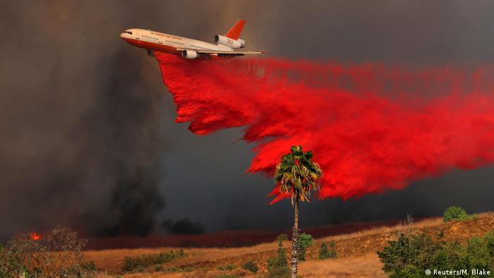 Air crews dropping fire retardant to stop the spread of the wildfires