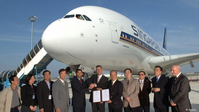 Singapore Airlines staff stand in front of their first Airbus A380 purchase (Airbus )