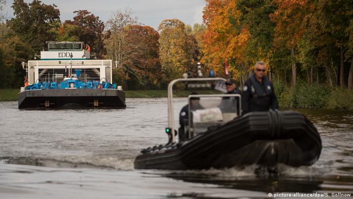 A police ship on the Neckar River ahead of the nuclear waste transporting barge