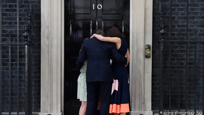 British Prime Minister David Cameron hugs his wife, Samantha, and family in front of 10 Downing Street.