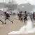 People running from tear gas during protests in Togo's capital Lome