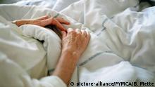 Elderly womans hands in a hospital bed in Copenhagen |