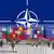 NATO logo with member flags