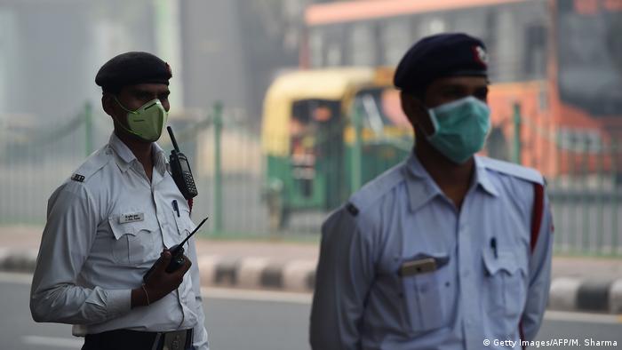 Indian policemen wear protective masks to protect themselves from heavy smog in New Delhi