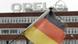 A fraying German flag in front of an Opel factory A fraying German flag in front of an Opel factory
