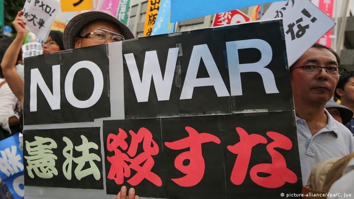 Protesters shout anti-government slogans, carrying placards that read: No war